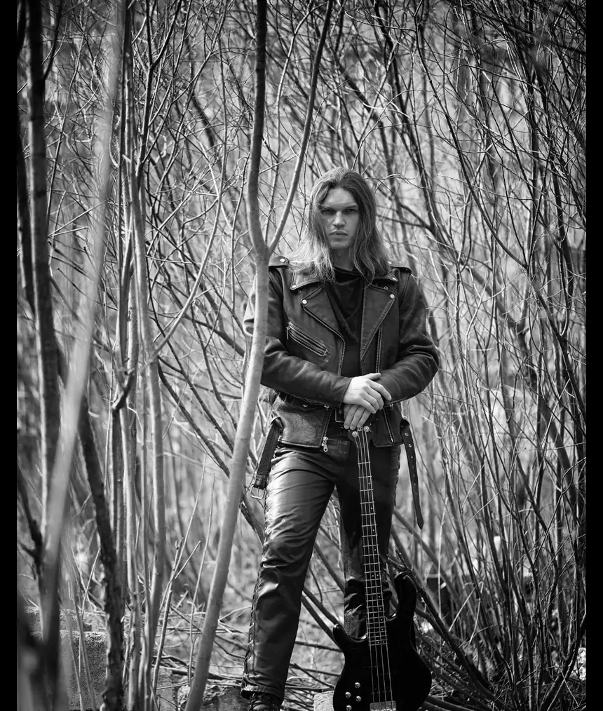 Editorial black-and-white band photo in a forest.