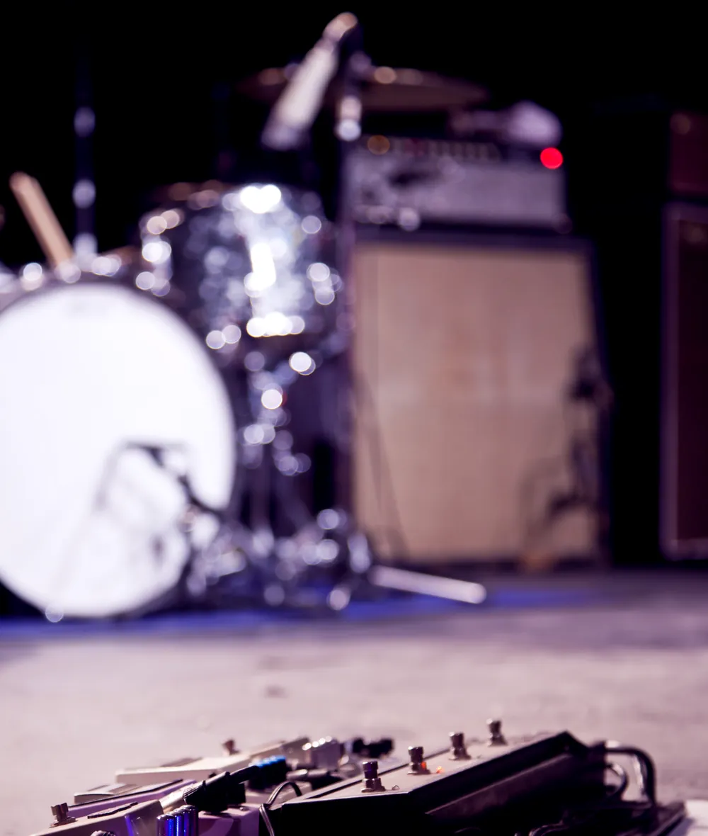 Amplifiers and a drum kit on stage.